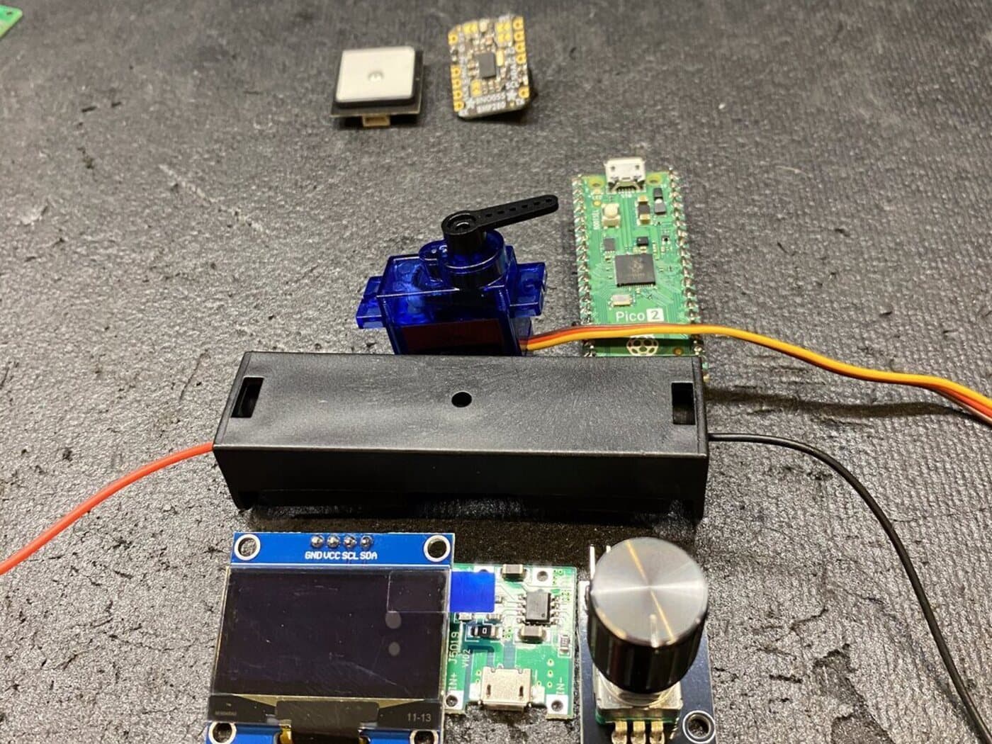The parts it runs on — GPS, microcontroller, servo, and display